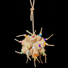Load image into Gallery viewer, Two dozen cork stoppers with pony beads tied onto a perforated golf ball base with twisted paper cord. The toy hangs from a strip of veggie tanned leather lace. Designed for intermediate sized birds such as small conures, cockatiels, quakers, ringnecks, etc. up to slightly bigger birds that like softer textured toys. Measures approx 5" by 10" including link.