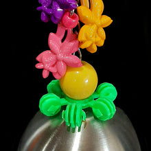 Load image into Gallery viewer, A bird friendly bell made with a brushed stainless steel cup with a large acrylic candy charm inside for the clanger. Large acrylic charms, beads and a snowflake ring are attached to the nickel plated chain the "bell" hangs from.