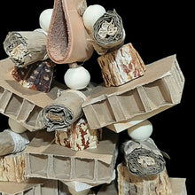 Load image into Gallery viewer, Cardboard honeycomb blocks, banana leaf rolls, mahogany chunks, uncolored pine wood slats and natural wood beads strung on jute cord. The base is a veggie tanned leather strap. Designed for intermediate up to medium sized birds that love soft textures to shred.