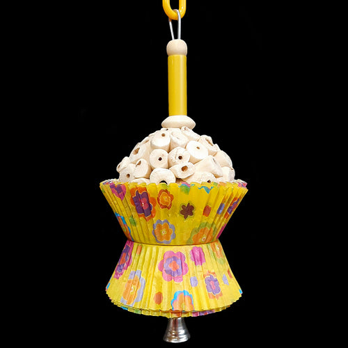 A super soft sola atta ball nestled inside colorful paper cupcake liners with a cork stopper hidden under the bottom liners. Strung on stainless steel wire with a plastic straw bead, wood beads and small nickel plated bell at the bottom. Designed for small birds such as parrotlets, budgies, small conures, cockatiels, etc. Available in assorted colors.  Measures approx 3