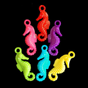 Acrylic charms in the shape of a seahorse measuring approx 1/2" by 1-1/4" with a 3mm (approx 1/8") hole.  Package contains 25 charms in assorted colors.