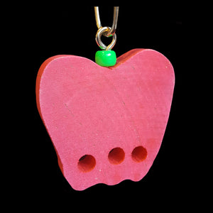 A brightly colored 2-1/4" by 1/2" thick hardwood apple with three 1/4" holes. Includes cool clip link for hanging.