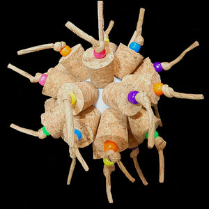 Two dozen cork stoppers with pony beads tied onto a perforated golf ball base with twisted paper cord. The toy hangs from a strip of veggie tanned leather lace. Designed for intermediate sized birds such as small conures, cockatiels, quakers, ringnecks, etc. up to slightly bigger birds that like softer textured toys. Measures approx 5" by 10" including link.