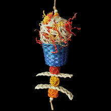 Load image into Gallery viewer, Handmade bird toy made with a giant bamboo ball filled with crinkle paper nestled inside a brightly colored woven bamboo basket with corn husk braids and mini vine balls trailing underneath. Strung on paper rope. 
