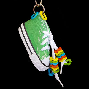 A miniature canvas tennis shoe decorated with colorful wiggle rings. Makes a great foraging toy - simply hide a treat or two inside for foraging fun! Note: Sneaker does not have metal grommets like some do!