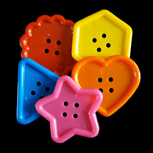Large, chewy plastic buttons in assorted shapes and colors measuring approx 2" in diameter.