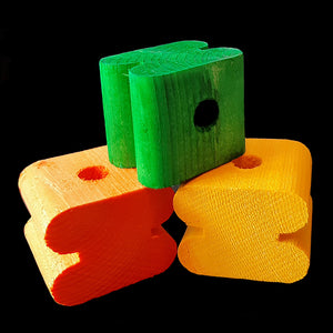 Brightly colored notched pine blocks measuring approx 1-1/4" by 1-1/2" by 1" with a 3/8" center hole. Recommended for medium and large birds.