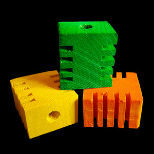 Brightly colored pine blocks measuring approx 1-3/4" by 1-1/2" by 1" with a 3/8" center hole. The blocks have grooves in two sides for easy chipping.  Package contains 6 blocks in assorted colors.