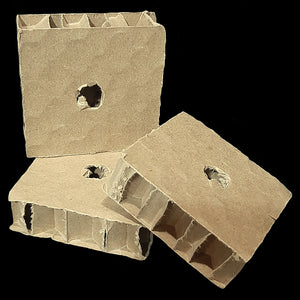 Corrugated cardboard honeycomb blocks measuring 2-1/2" by 2-1/2" by 3/4" with a 1/2" hole.