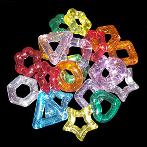 Little crystal-colored rings in assorted shapes (heart, star, flower, triangle, square and others) measuring approx 5/8" with holes ranging from 3/16" to 5/16" depending on shape.