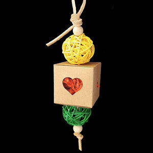 Crinkle-cut paper shred stuffed into a bird-safe craft paper box with brightly colored vine balls and wood beads strung on veggie tanned leather lace. Stuff small seeds, nuts or treats inside to encourage your bird to start foraging! Designed for small-sized birds.  Measures approx 2" by 9" including link.