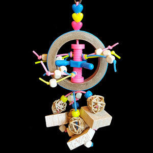 Little wood beads streaming out of a plastic bolt inside a birdie bagel with munch balls, balsa blocks & beads. Contains no metal parts.   Measures approx 3" by 8-1/2" including link.
