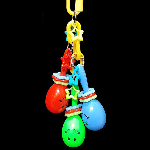 Three smiling mini maracas with spinning rings and charms dangling on plastic chain. Small birds will love the gentle rattle sound and action of the brightly colored movable parts. Comes in assorted color combinations.  Measures approx 6-3/4