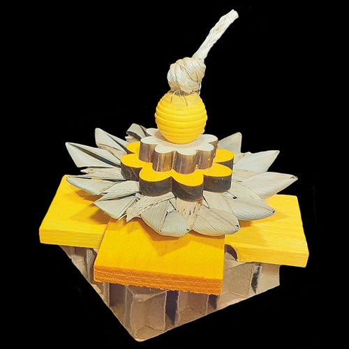 A multi-textured toy made with pine daisies, softwood pine slats and a crunchy palm leaf flower on top of a cardboard block. Designed for bunnies and can also be enjoyed by small birds as a cage top toy. Available in assorted colors.