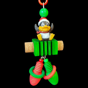 A festive penguin sitting atop a notched pine block with cork inserted in the sides and wood Christmas lights and rings dangling underneath. The base of this toy is stainless steel wire. Designed for small to intermediate sized birds.  Measures approx 3" by 7-1/2" including link.