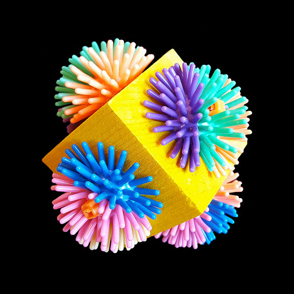 A brightly colored pine cube with spiny porcupine ball halves attached to each side. Designed for medium to large parrots.  Measures approx 3