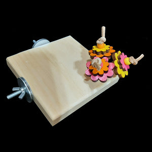 A 3/4" thick pine wood platform corner perch with brightly colored pine daisies on veggie tanned leather lace sprouting of the corner. A great alternative perching spot for birds with special needs or a different place for resting tired feet! Many birds will also enjoy chewing on the wood, providing hours of entertainment and beak exercise.