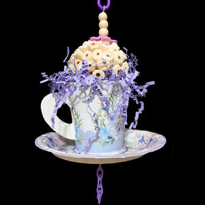 Your bird is sure to have a party with this super-soft sola ball nestled inside a paper tea cup and saucer! The cup is stuffed with crinkle paper shred and has a cork stopper hidden inside. Strung on stainless steel wire with small wood snap beads and pla