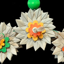 Load image into Gallery viewer, An adorable swing that doubles as a shreddable toy! Made on a large birdie bagel with six crunchy palm leaf flowers (three on each side) and brightly colored pine daisies and wood snap beads on jute cord. Designed for intermediate sized birds such as senegals, caiques, ringnecks, quakers or even a couple smaller birds.
