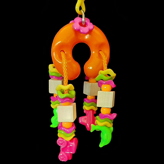 Wiggle rings, pony beads and little wood blocks strung on paulie rope through a puffy plastic horseshoe. The ends of the rope have assorted fun shaped beads firmly attached for long lasting tugging fun. Available in assorted colors.
