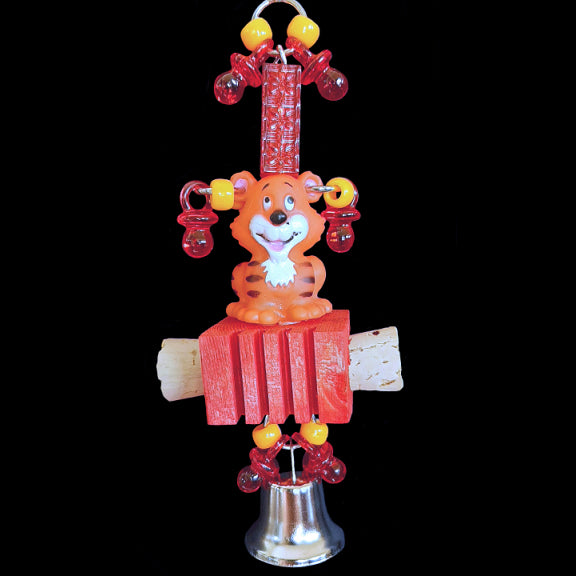 A rubber tiger decked out with mini pacifiers & pony beads sitting atop a notched pine block with corks on the sides and a big shiny bell on the bottom. Built on nickel plated chain.