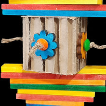 Load image into Gallery viewer, Brightly colored wood blocks of various sizes with a cardboard honeycomb kraft cube decorated with pine daisies and wood beads. Strung on jute rope.
