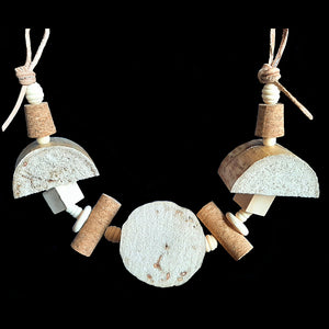 An assortment of soft yucca chunks, corks and assorted wood pieces strung on a veggie tanned leather strip. Designed for small to intermediate birds. Can be strung horizontal or vertical in your bird's cage.  Measures approx 19" across including links.