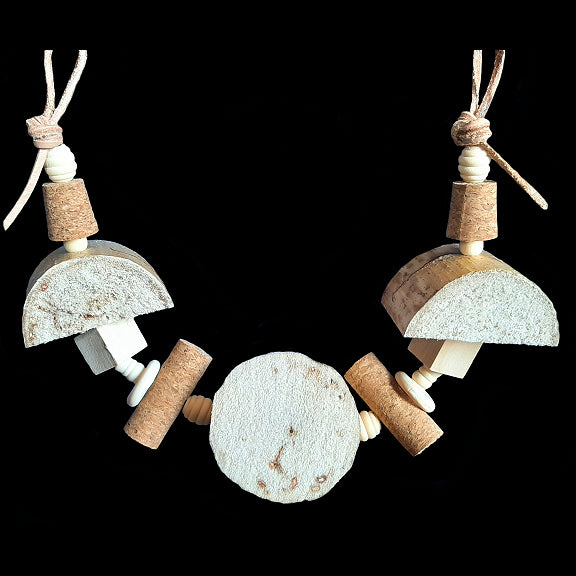 An assortment of soft yucca chunks, corks and assorted wood pieces strung on a veggie tanned leather strip. Designed for small to intermediate birds. Can be strung horizontal or vertical in your bird's cage.  Measures approx 19
