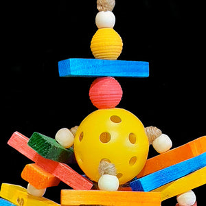 Almist fiive dozen brightly colored mini pine slats with wood snap beads threaded on jute cord on a perforated golf ball base. The perfect toy for conures that like to chew and hang on their toys!