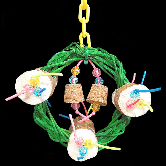 A four inch vine ring wreath adorned with super soft sola coins, small cork stoppers and little beads strung on plastic lacing cord. Hangs from a length of plastic chain. Designed for small birds such as budgies, parrotlets, lovebirds, linnies, etc.  Meas